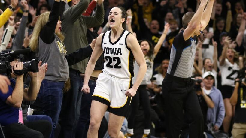 IOWA CITY, IOWA- FEBRUARY 15: Caitlin Clark #22 of the Iowa Hawkeyes celebrates after breaking the NCAA women's all-time scoring record during the first half against the Michigan Wolverines at Carver-Hawkeye Arena on February 15, 2024 in Iowa City, Iowa. (Photo by Matthew Holst/Getty Images)