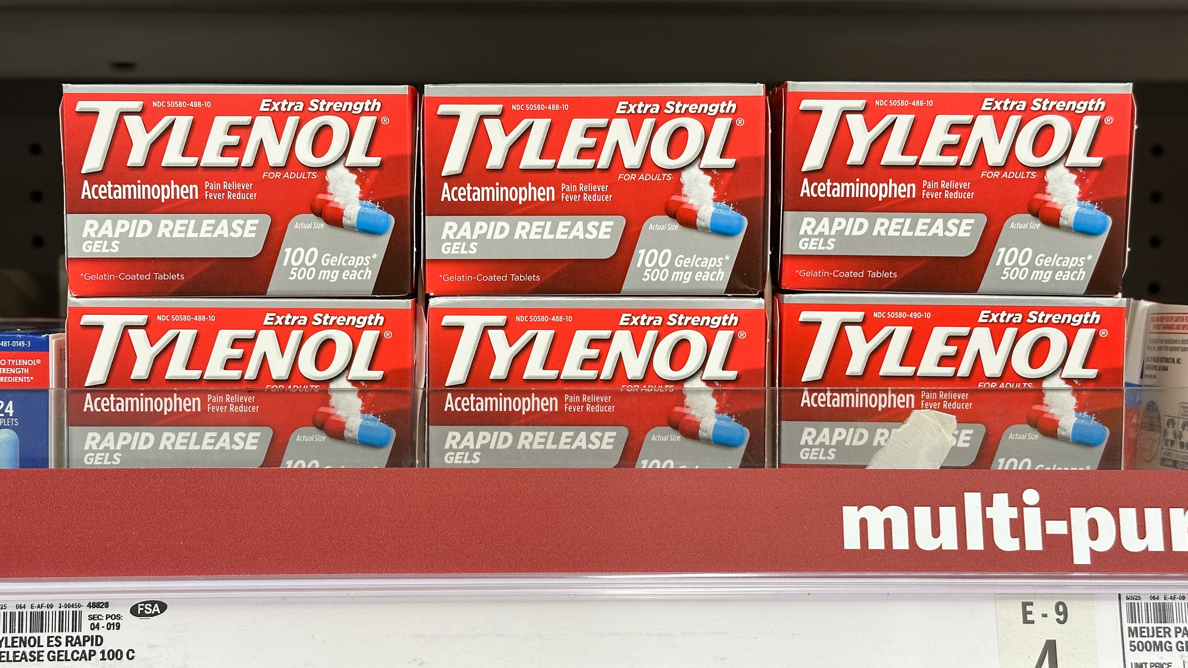 Boxes of Tylenol extra strength rapid release pain reliever and fever reducer neatly arranged on the shelves of a Meijer pharmacy section